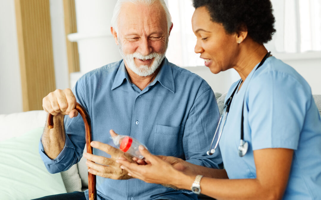 Smiling companion caregiver in West Palm Beach, FL chatting with happy senior during home visit