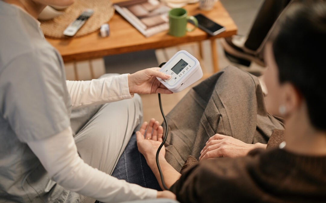Caregiver assisting senior with blood pressure and glucose monitoring in Royal Palm Beach, FL.