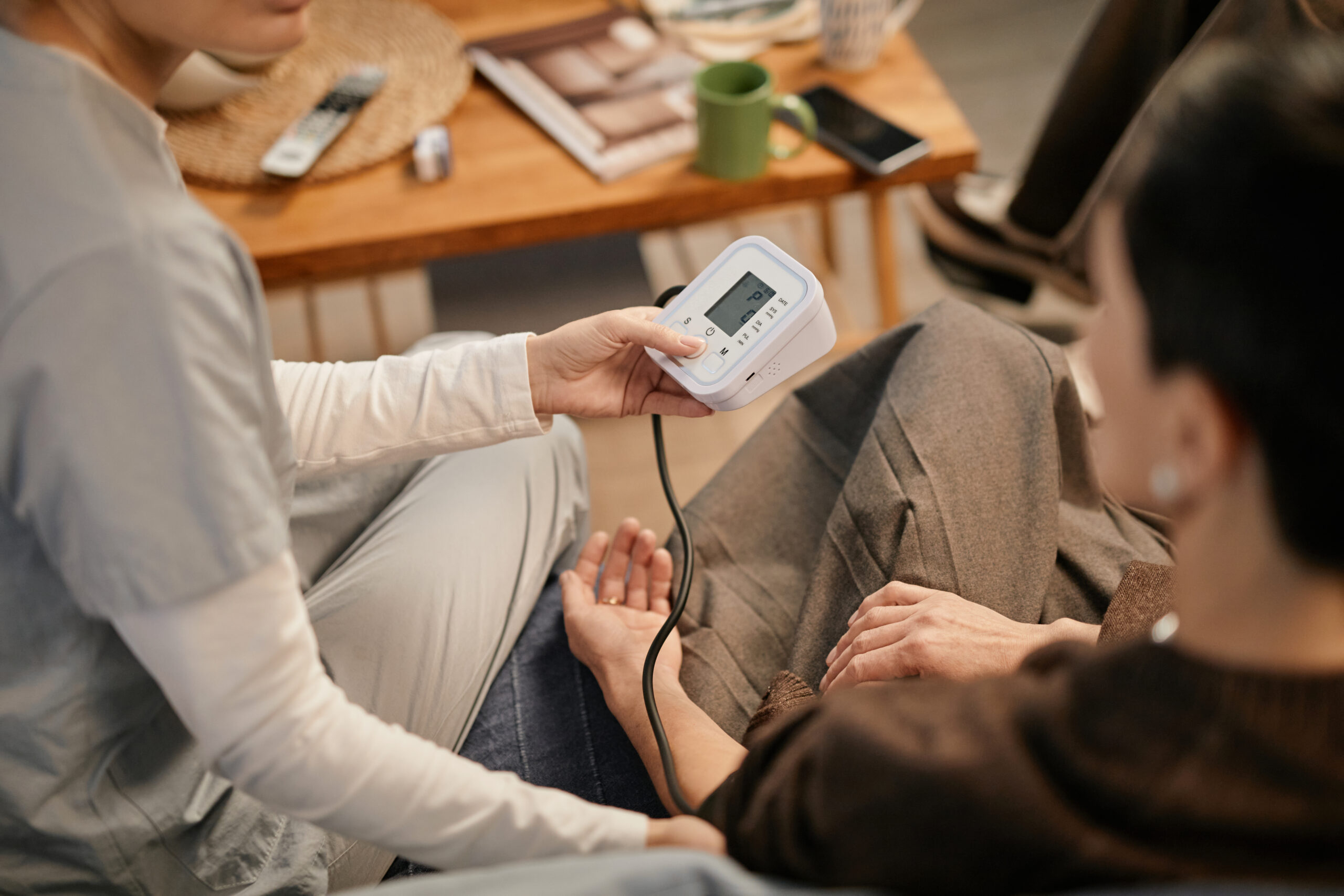 Caregiver assisting senior with blood pressure and glucose monitoring in Royal Palm Beach, FL.